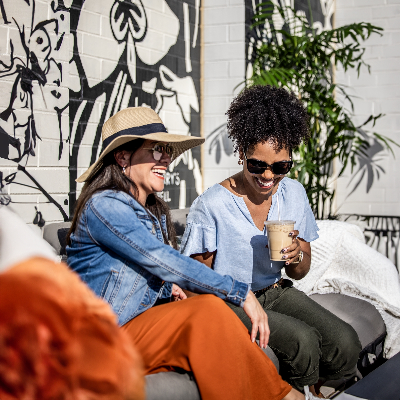 Two women enjoying a friendly conversation at Kinston Hub over a few refreshing beverages