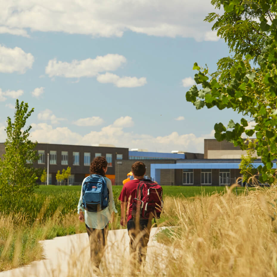 Two students walking and talking as they make their way to school