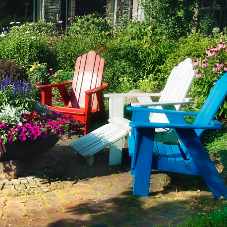 Three Adirondack chairs soaking in the summer sun