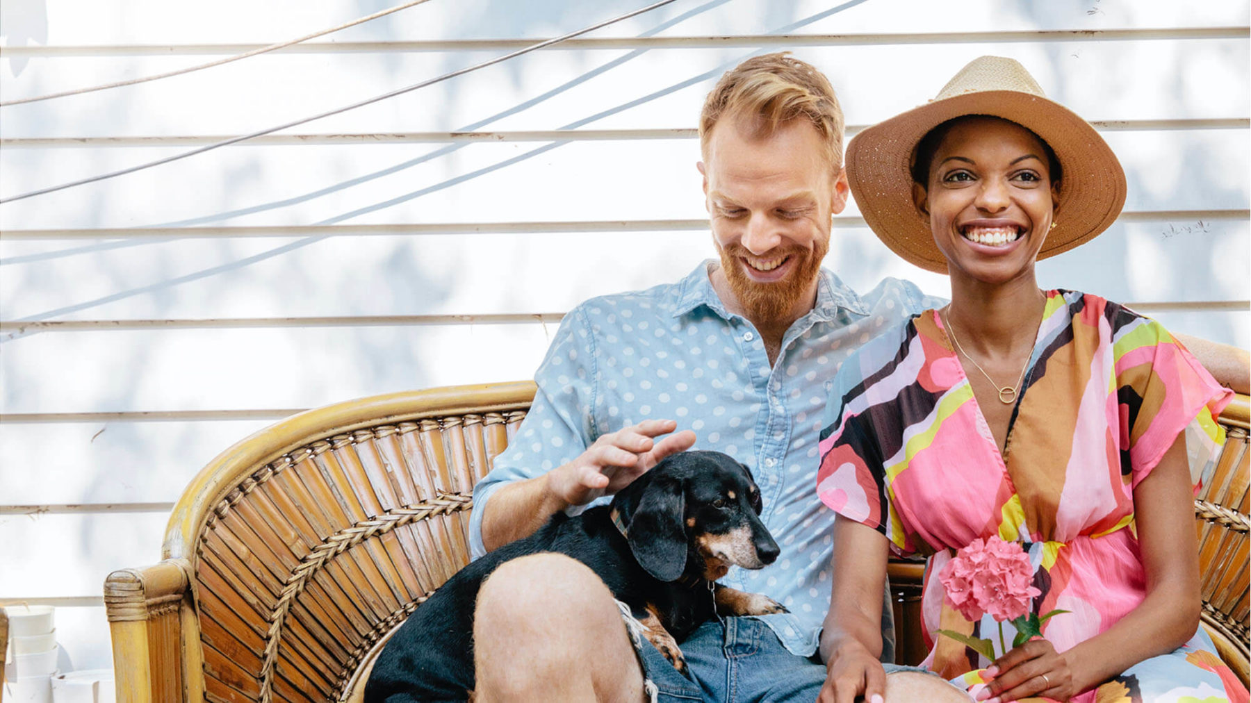 A couple and their dog sit outside of their Kinston home in Loveland, Colorado