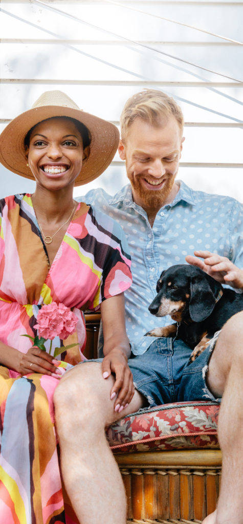 A couple and their dog sit outside of their Kinston home in Loveland, Colorado