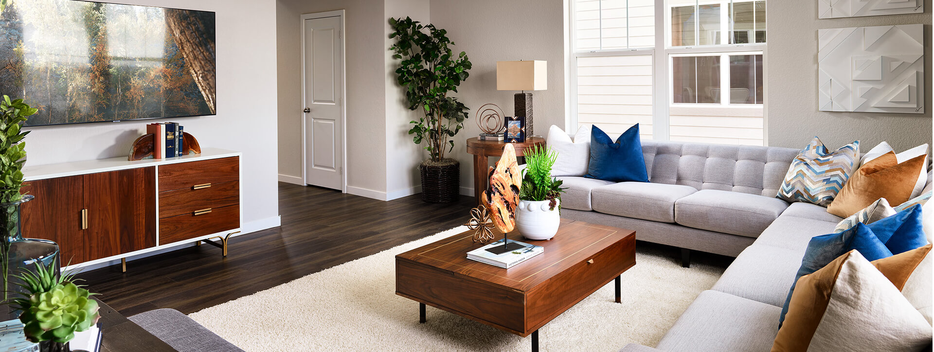 Spacious and comfortable living room in a Kinston home with white walls and a deep wood coffee table