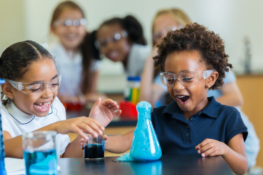 A classroom full of students performing an exciting science experiment for the first time