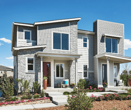 Exterior shot of a modern Richmond American paired home with grey siding and intriguing rooflines, coming soon to Kinston