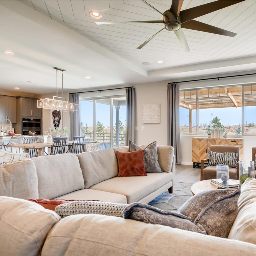 A large living room with a ceiling fan.