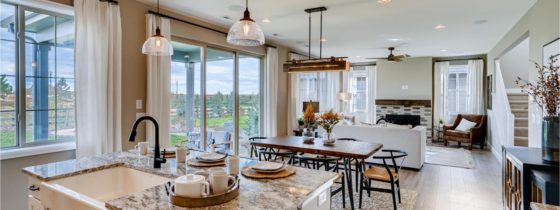 A kitchen and dining area with a view of the outdoors.