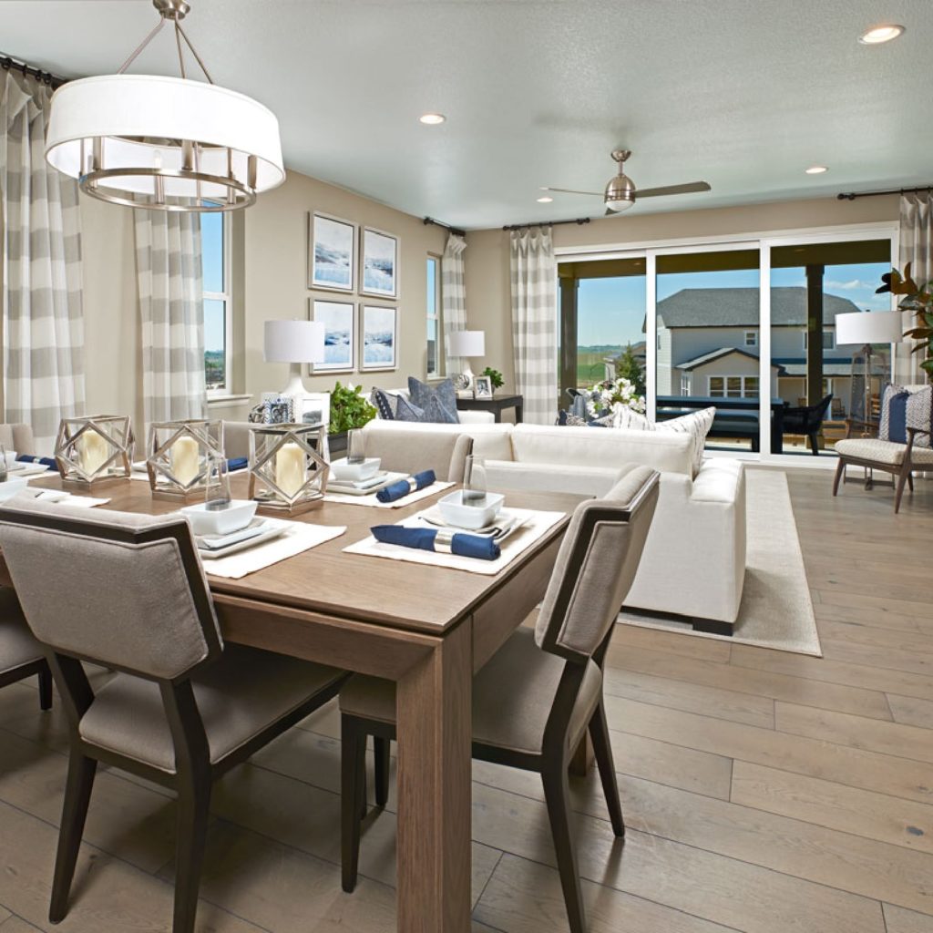 A living room with a dining table and chairs.