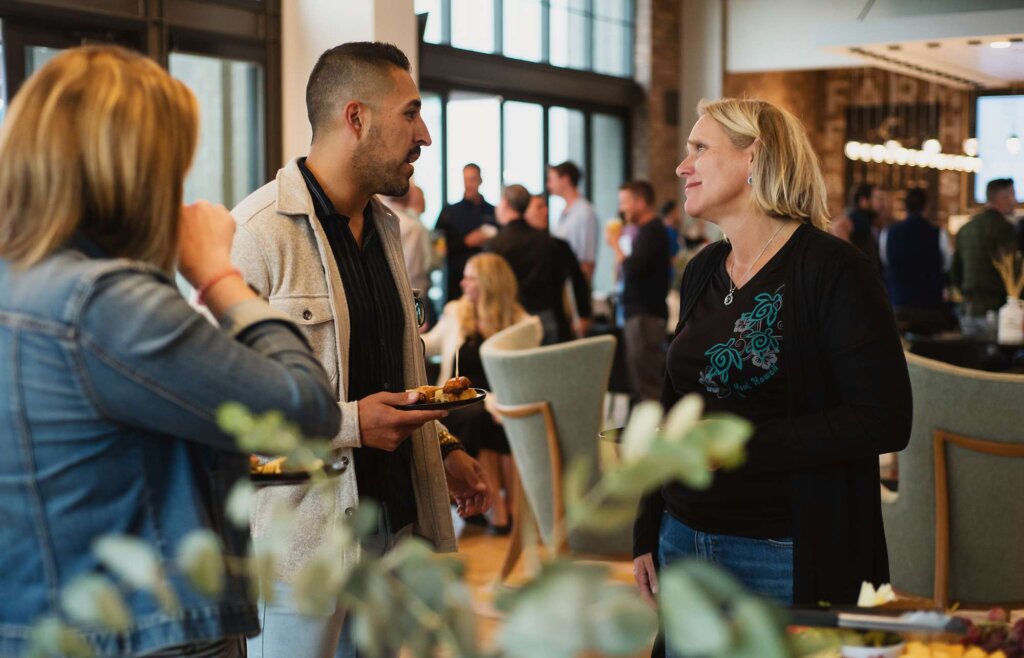 A group of people talking at a business event.