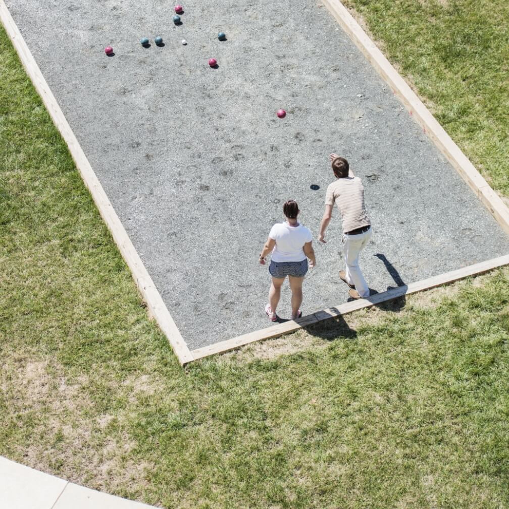 A couple playing Bocce ball