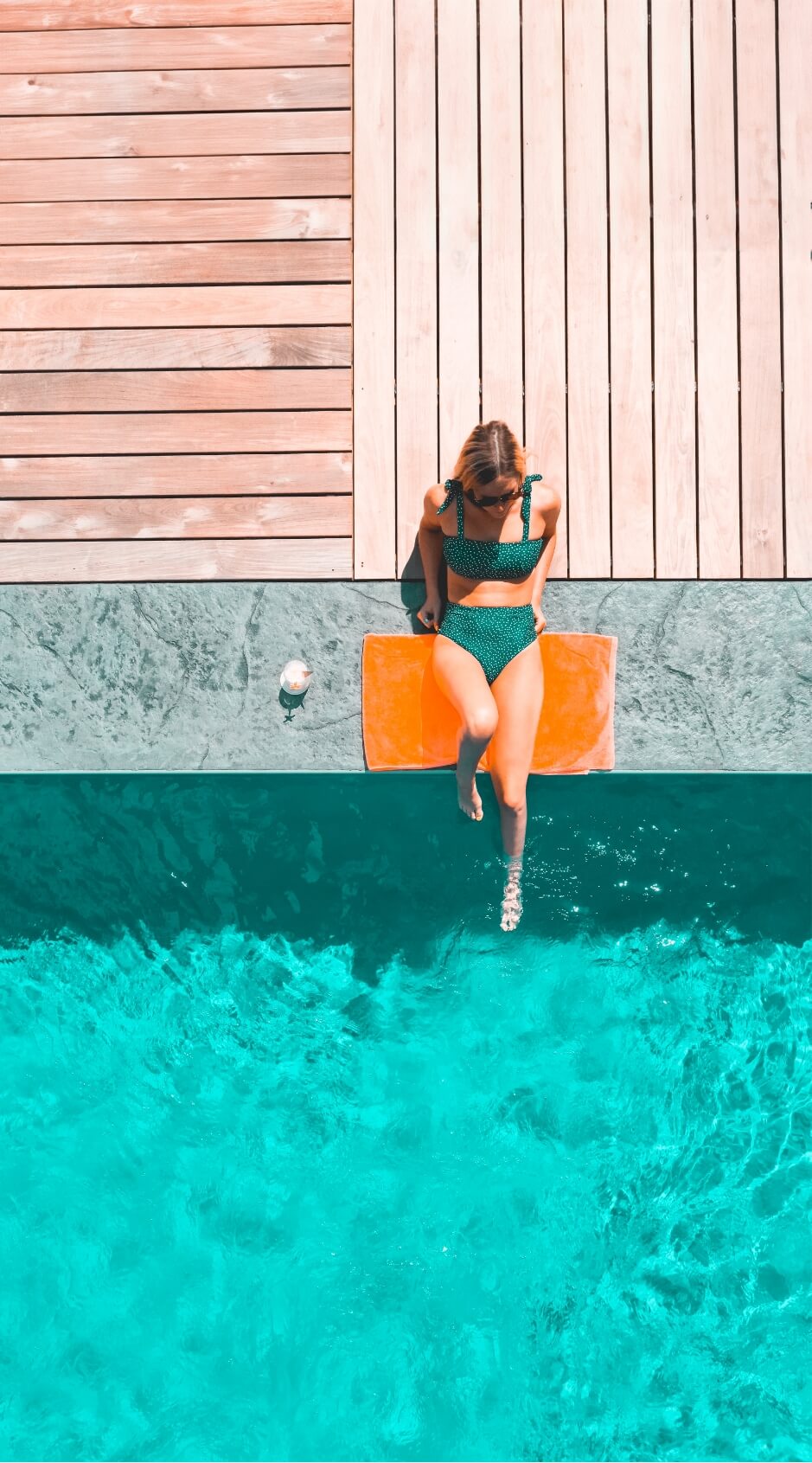 A swimmer relaxing near the pool