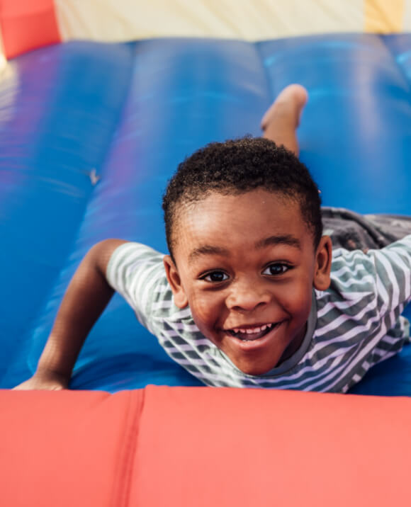 image of child playing on an inflatable playground