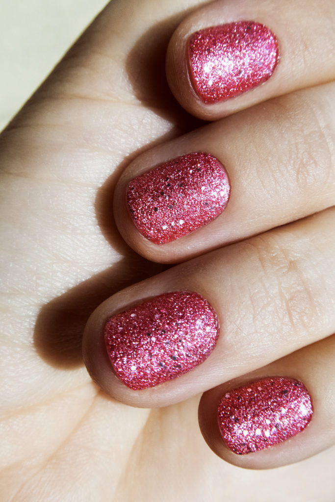 Close up image of pink glitter nails