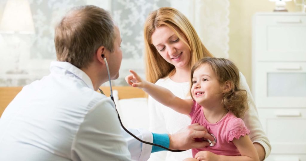 Image of mom and daughter being checked out by a doctor