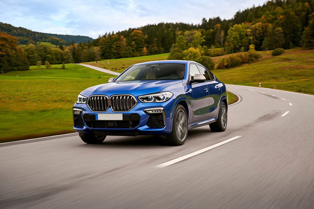 Image of BMW car driving on a road