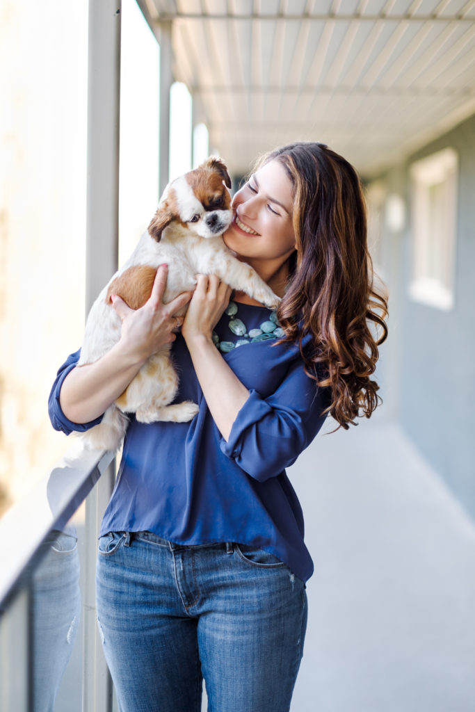 Image of woman playing with dog outside