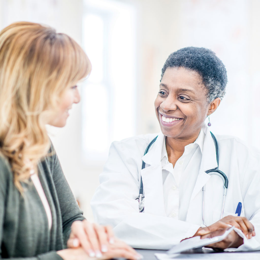 Image of woman sitting with a doctor