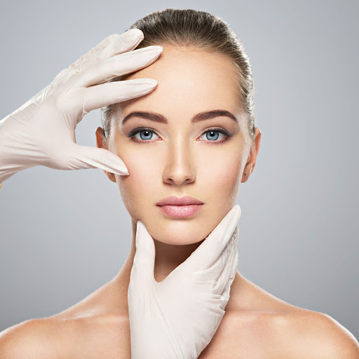 Image of a doctor's hands examining a woman's face