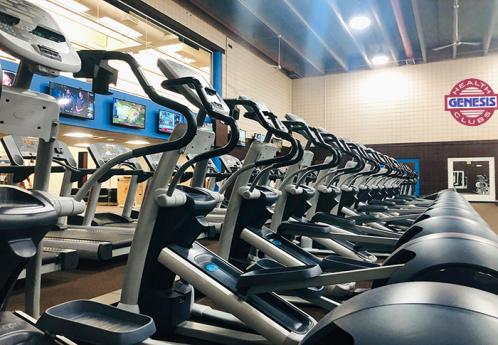 Image of a line of elliptical machines at a gym