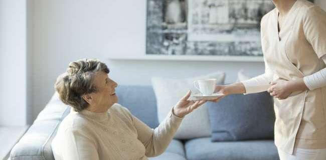 Smiling senior woman sitting on the sofa at a nursing home