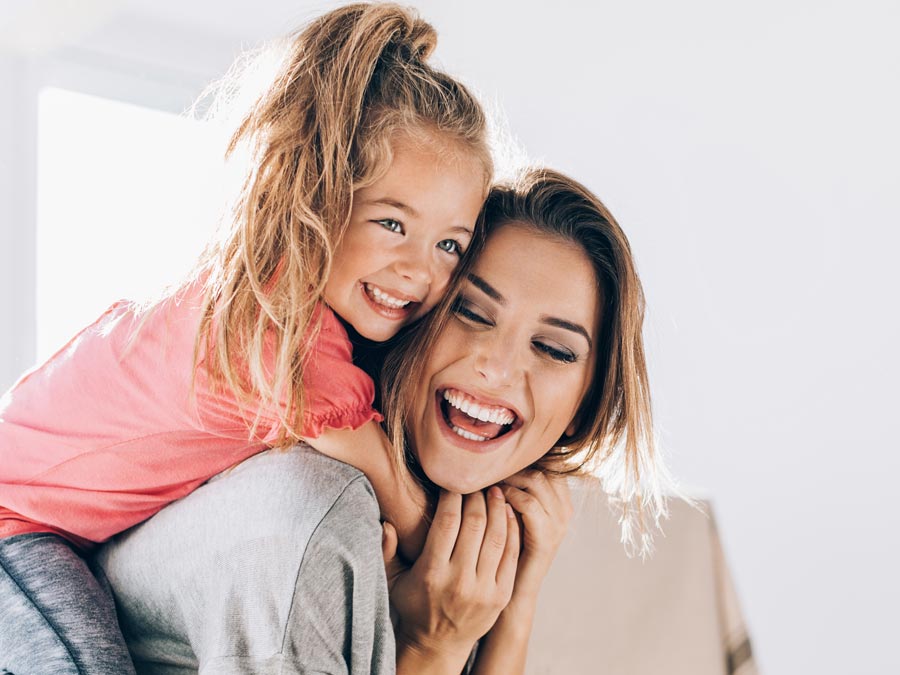 Image of daughter playing on mother's back