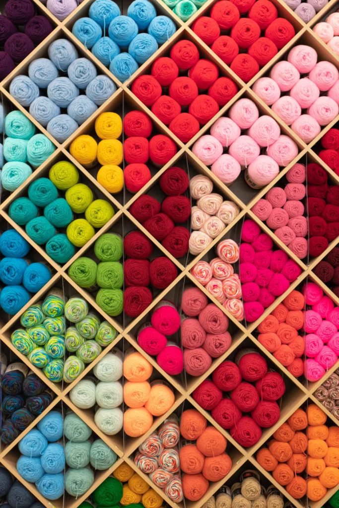 Image of a wall of multi-colored yarn