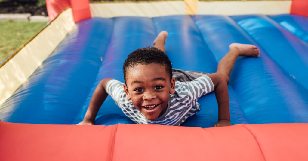 Image of a boy playing on an inflatable playhouse