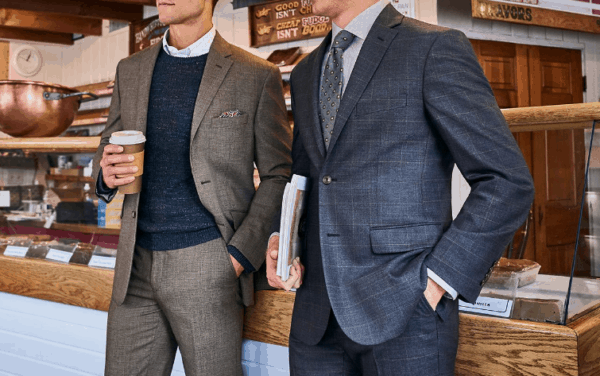 Image of two men wearing nice suits in a coffee shop