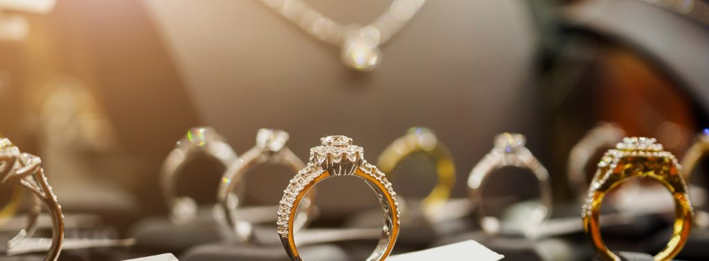 Image of multiple engagement rings and a diamond necklace