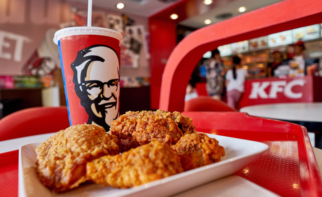 Image of a plate of fried chicken with a KFC cup