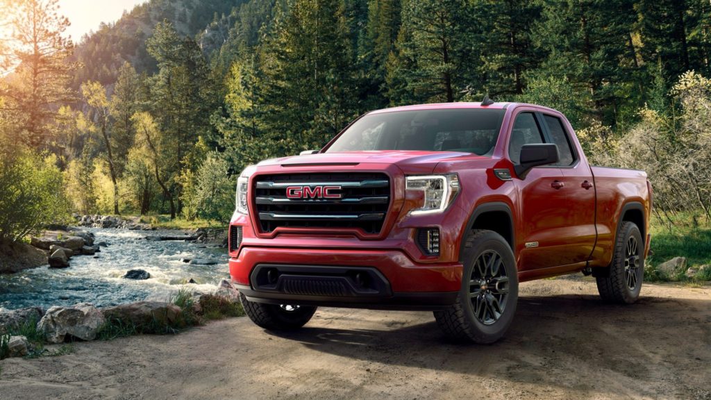 Image of a GMC pickup truck next to a river