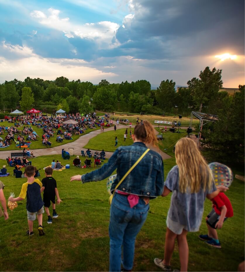 Image of people walking down a hill towards an event lawn