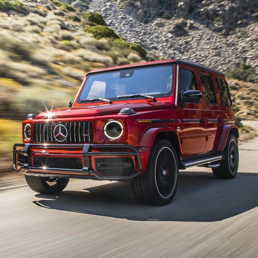 Image of red Mercedes Benz car driving on road