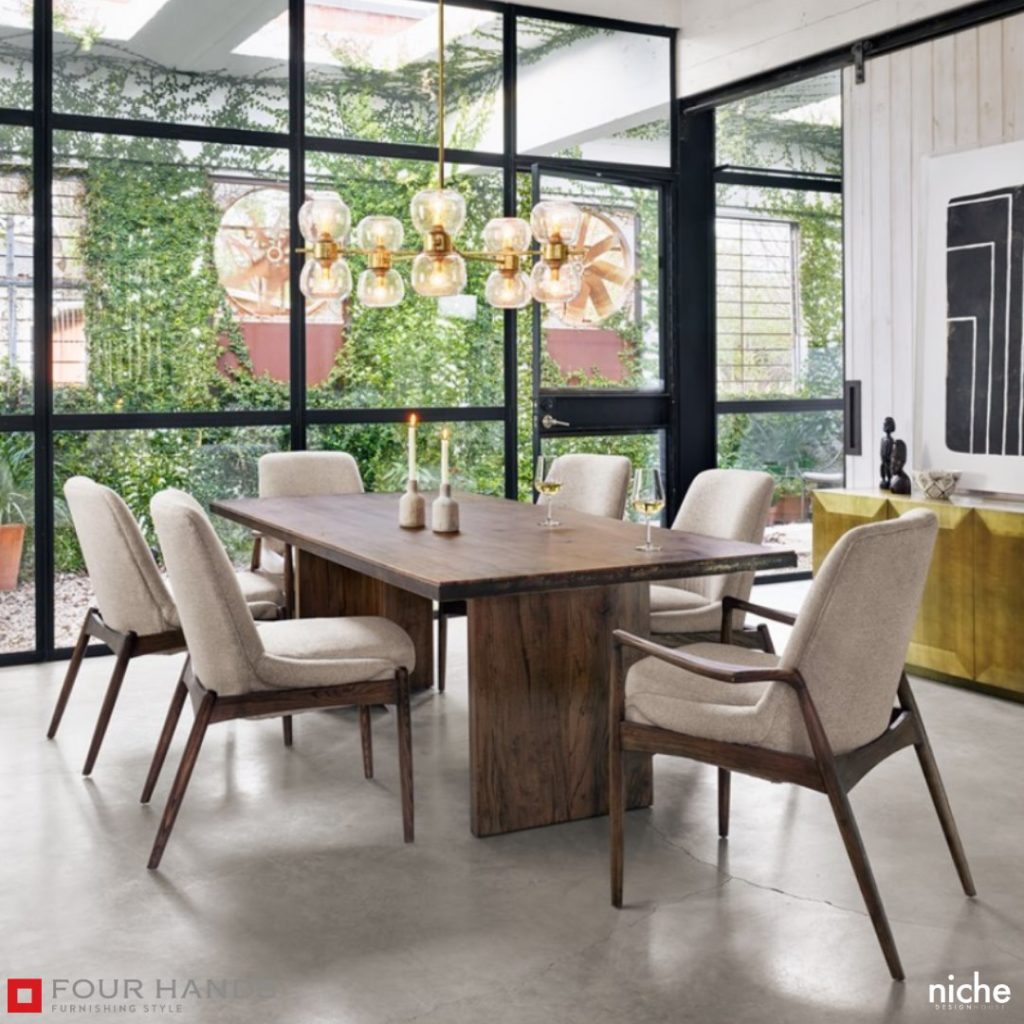 Image of a dining room table with 6 chairs, 2 candles, 2 wine glasses, and a large chandelier