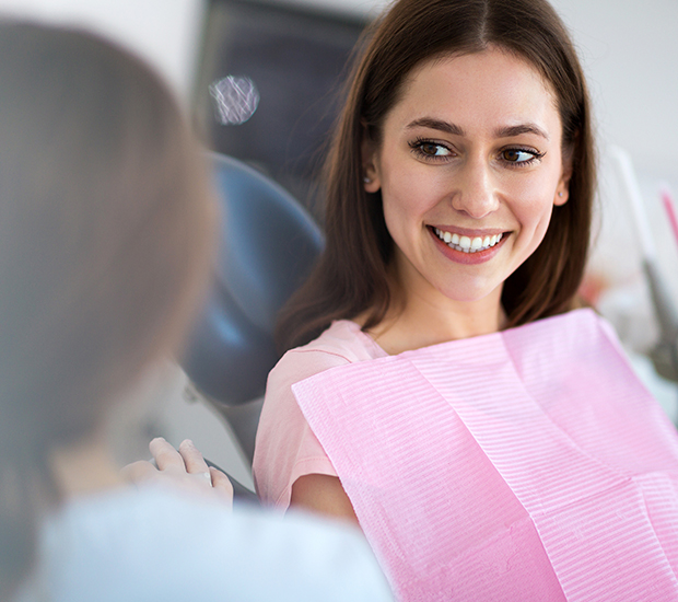 Image of smiling woman getting a dental examination