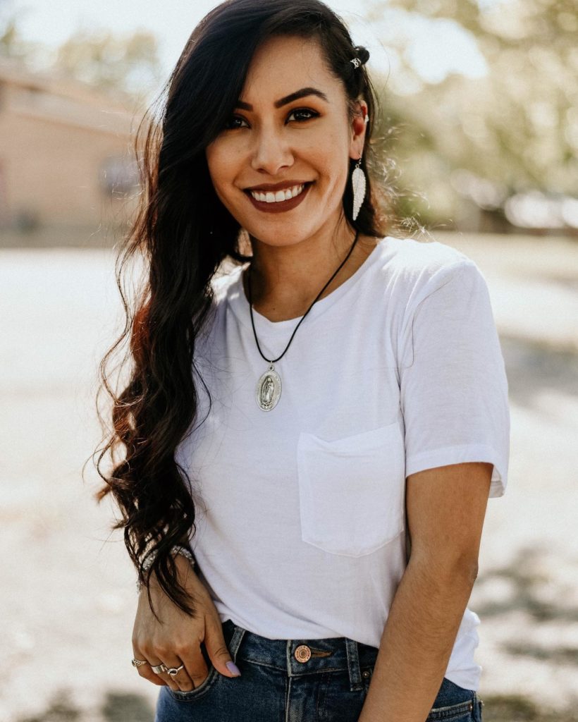 Image of woman smiling while wearing clothes and jewelry from Ross store