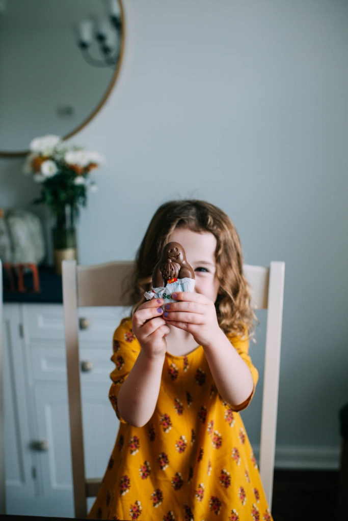 Image of girl holding up a chocolate bar that is shaped like a ghost