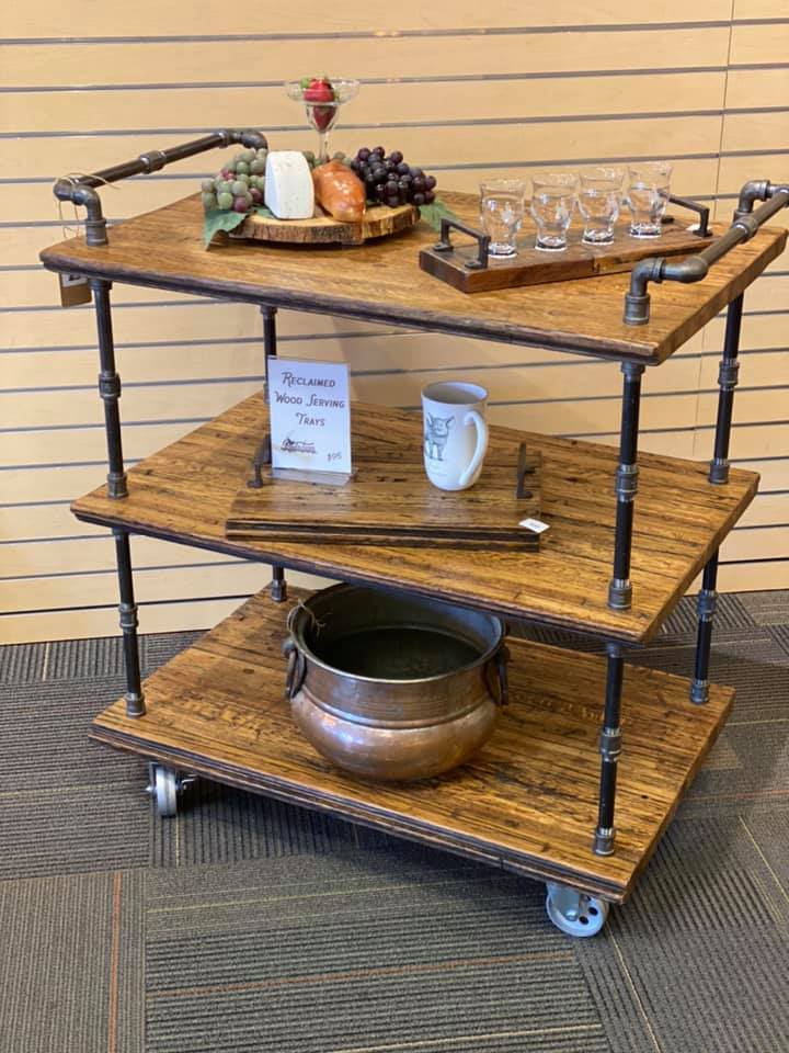 Image of a bar cart with glasses, copper pot, and fruit and cheeses