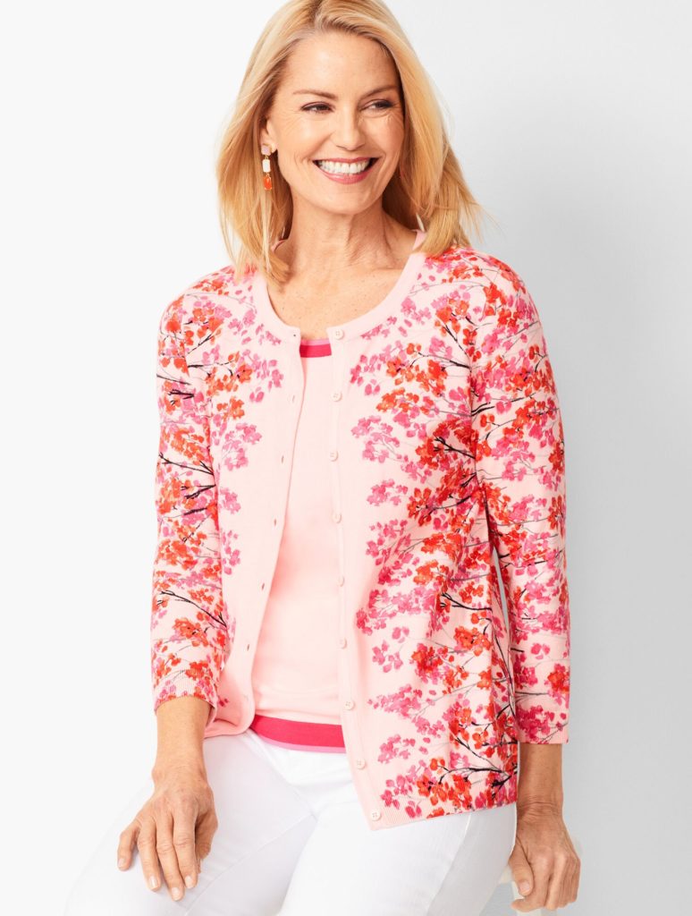 Image of smiling woman wearing a pink shirt and cardigan from Talbots store