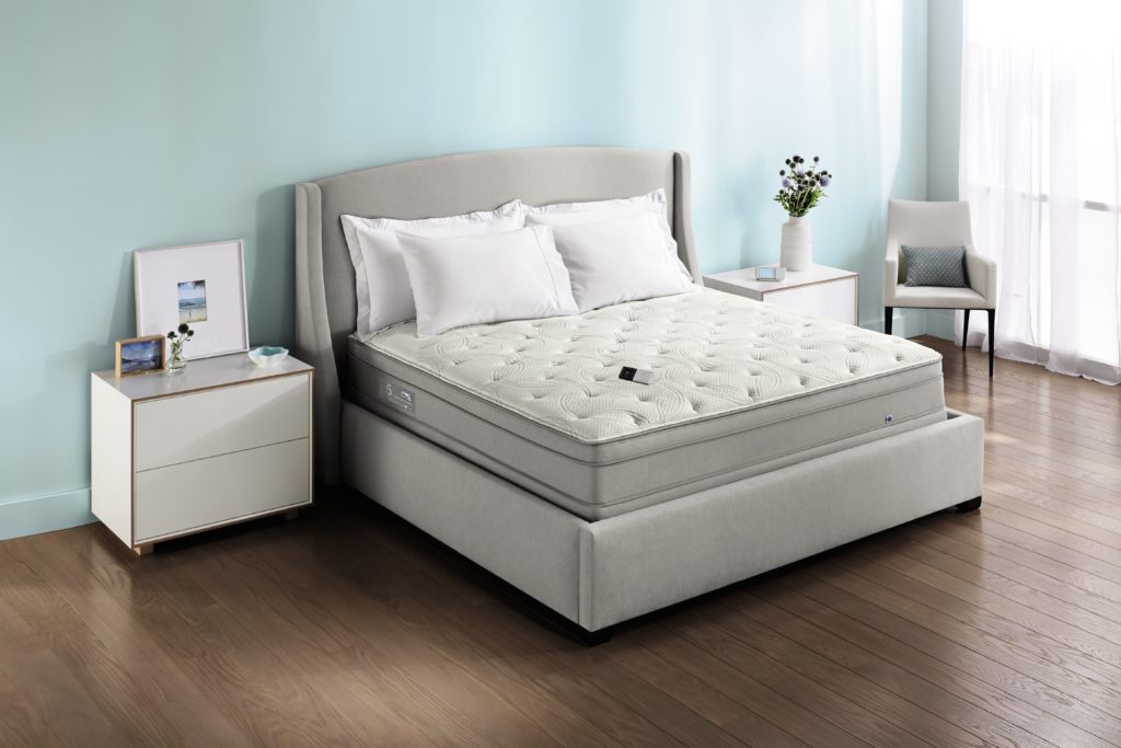 Image of a Sleep Number mattress in a bedroom with taupe colored bed frame
