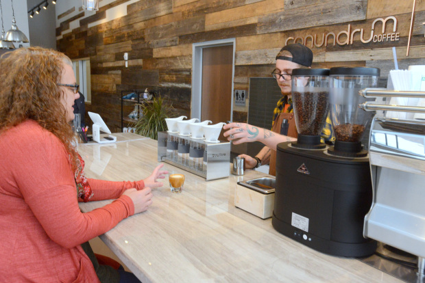 Interior image of a woman ordering a cup of coffee at Toddy's