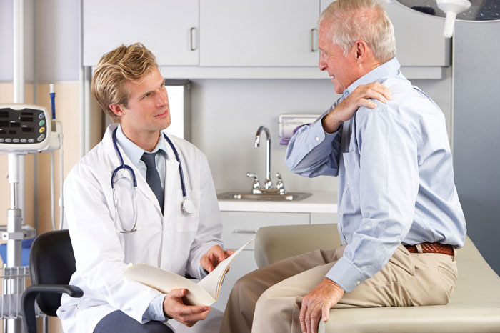 Image of senior man getting examined by a doctor