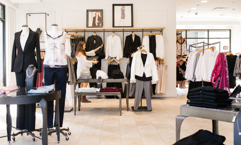 A woman is shopping in a Certified Wild clothing store.