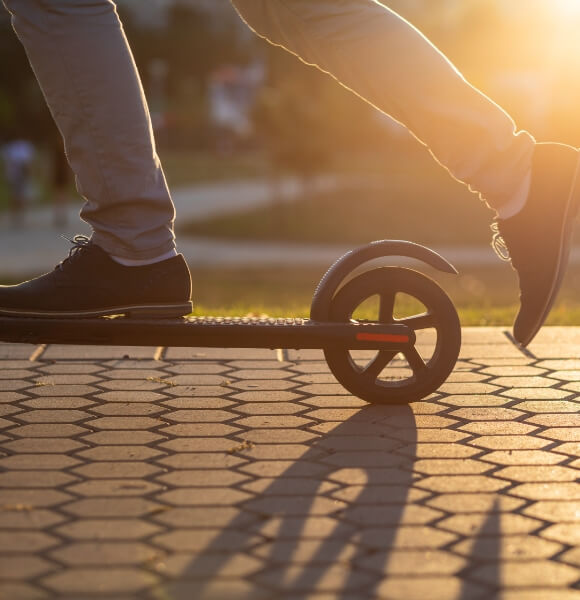 Close up image of a person's feet on a scooter