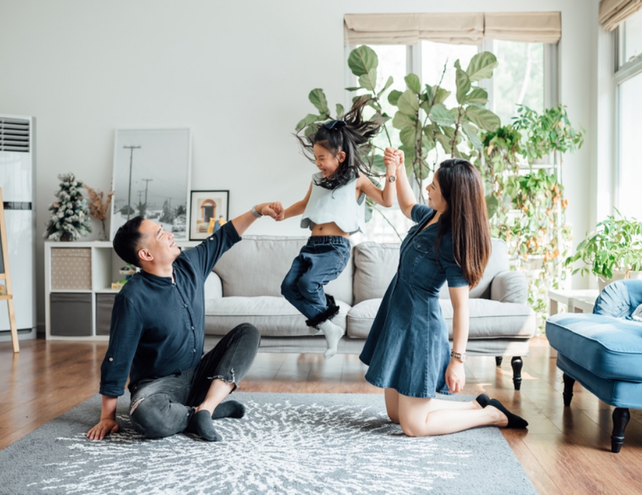 Image of parents playing with daughter