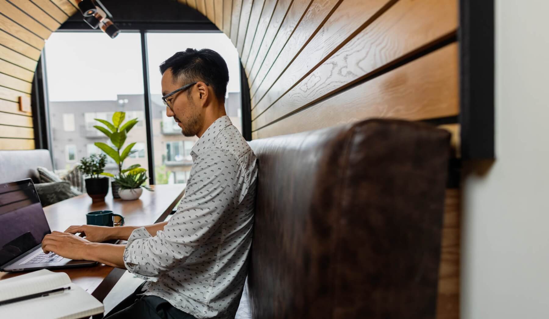 Image of man working at a booth table