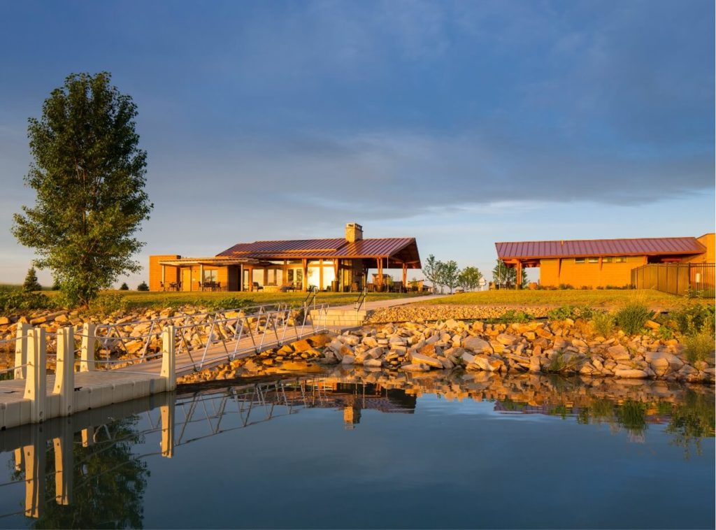 A certified wild house sits on a dock next to a body of water in Northern Colorado.