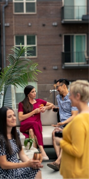 A group of people enjoying dining on a rooftop patio in Loveland.