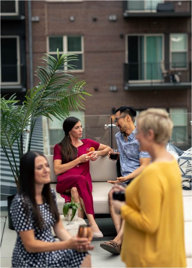 A group of Certified Wild people sitting on a patio talking to each other in their New Homes in Northern Colorado.