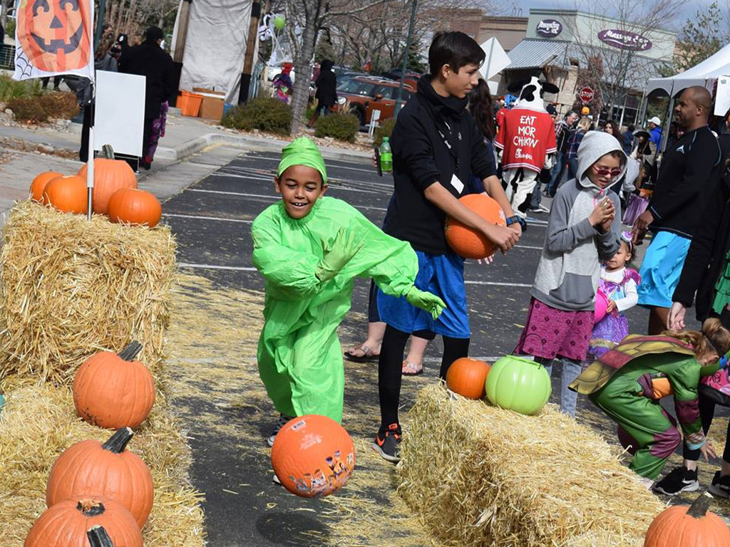 boy bowling a pumpkin at Halloween Hullabaloo