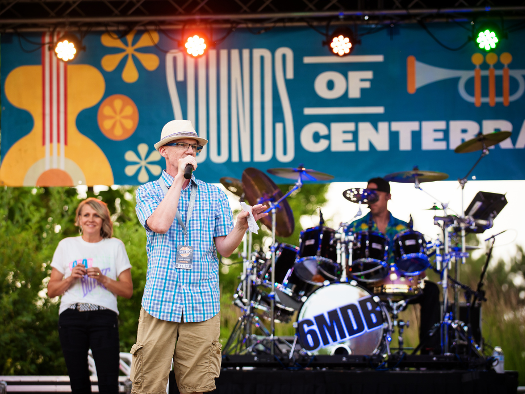 man on stage at sounds of centerra